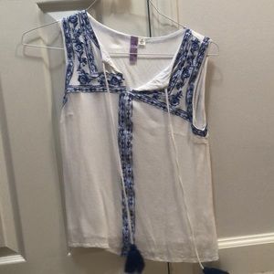 White top with blue flowered trimming